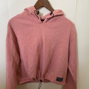 Mauve/pink crop top sweatshirt.